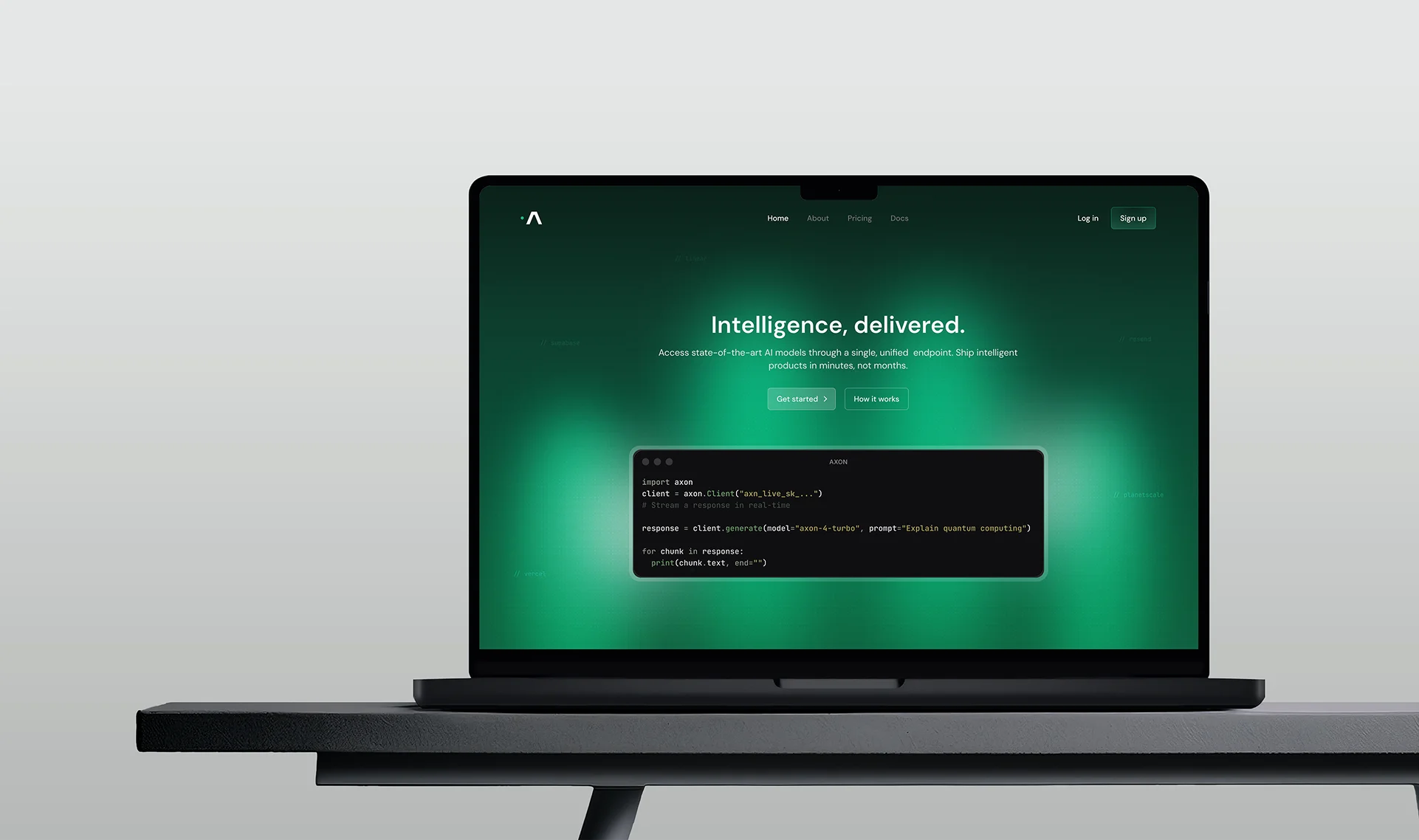 Axon homepage shown on a MacBook: the headline 'Intelligence, delivered.' with a unified API code sample.